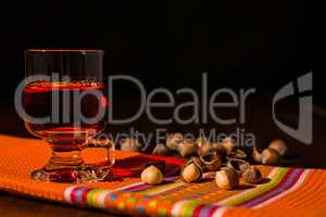 Glass of alcoholic punch drink and hazelnuts
