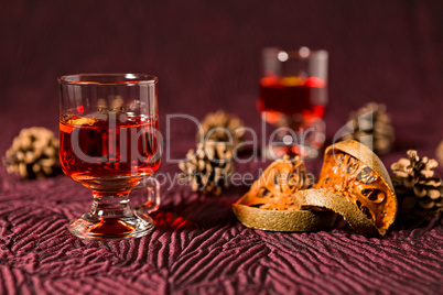 Alcoholic punch drink, dried orange fruit and pine cone