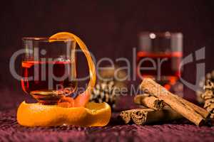 Closeup of alcoholic punch drink with orange peel and cinnamon s
