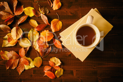 Cup of tea, books and autumnal foliage
