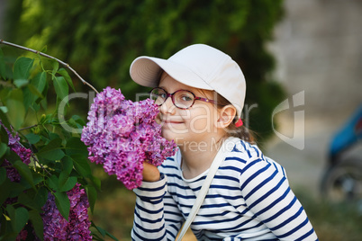 Girl smelling lilac