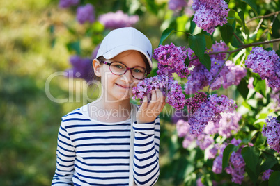 Girl smelling lilacs