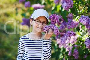 Girl smelling lilacs