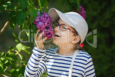 Child smelling lilac