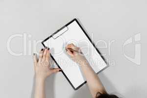 Woman writes on paper