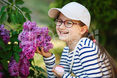 Laughing girl and lilacs