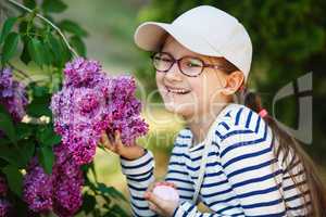 Laughing girl and lilacs
