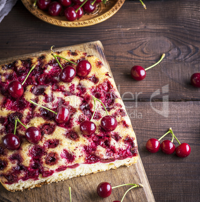 baked cherry pie on a brown wooden board