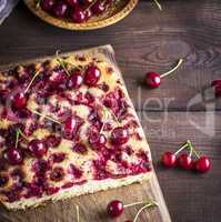 baked cherry pie on a brown wooden board