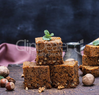 stack of baked square slices of pie with walnuts