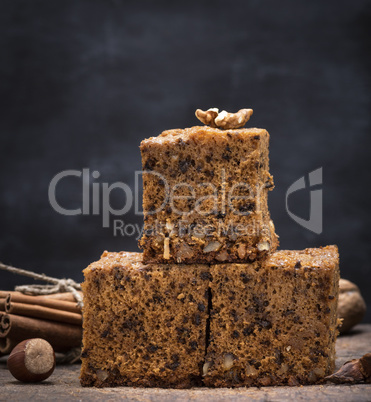 stack of baked square slices of a pie with walnuts