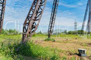 New poles for power lines lying on the ground. For the next installation in the design position.