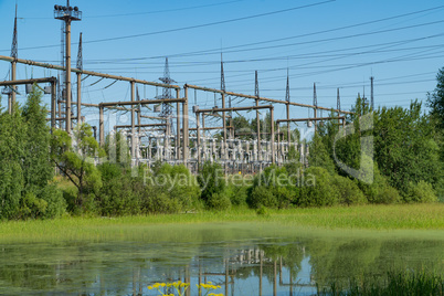 Power station near the pond. Power lines.
