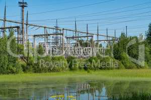 Power station near the pond. Power lines.