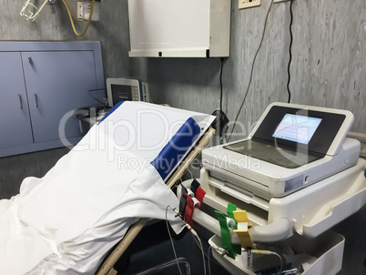 bed and medical equipment in a public emergency room