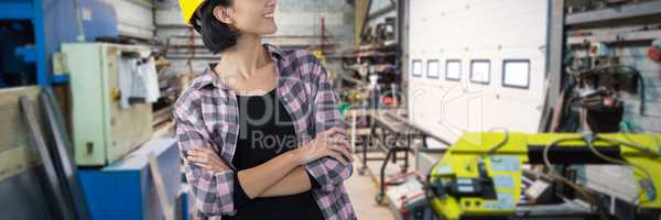 Composite image of female architect standing with arms crossed against white background