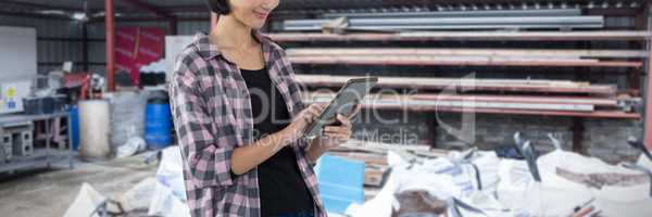 Composite image of female architect using digital tablet against white background