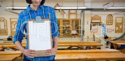 Composite image of architect holding clipboard against grey background