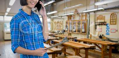 Composite image of female architect talking on mobile phone