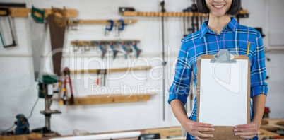 Composite image of female architect holding clipboard against grey background