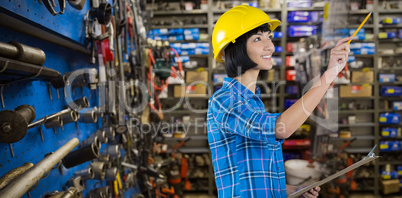 Composite image of female architect holding clipboard and gesturing against grey background