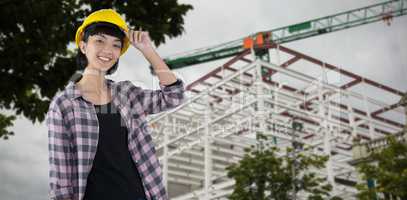 Composite image of female architect in hard hat standing against white background