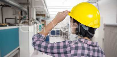 Composite image of female architect wearing hard hat against white background