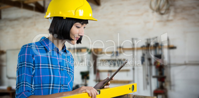 Composite image of female architect measuring plywood with engineer scale