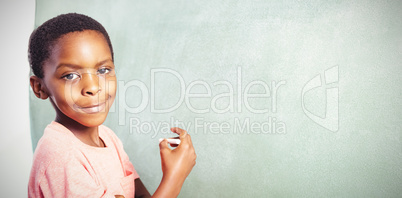 Portrait of boy standing by greenboard