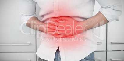 Composite image of mid section of man suffering from stomach pain