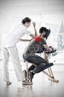 Composite image of female therapist giving back massage to man