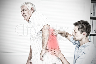 Composite image of male physiotherapist examining senior mans back