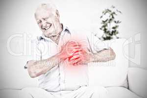 Composite image of old man suffering with heart pain
