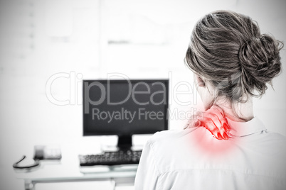 Composite image of rear view of a businesswoman with neck pain in office