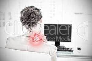 Composite image of rear view of businesswoman with neck pain in office