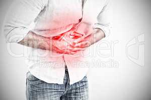 Composite image of mid section of man suffering from stomach pain
