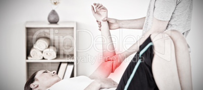 Composite image of young woman having an arm massage