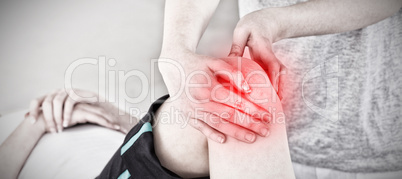 Composite image of masseuse massing the knee