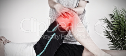 Composite image of masseuse massing the knee