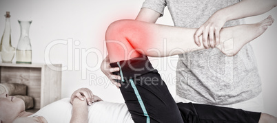 Composite image of masseuse stretching the right leg of an athletic woman
