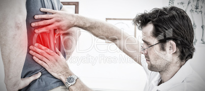 Composite image of side view of a male physiotherapist examining mans back