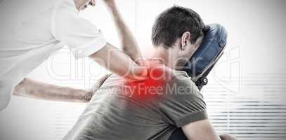 Composite image of therapist giving back massage to man