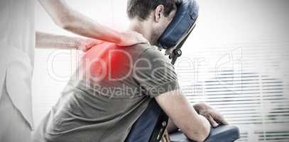 Composite image of physiotherapist giving shoulder massage to man