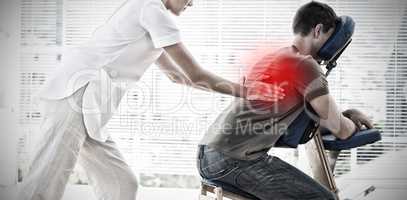 Composite image of man receiving back massage from physiotherapist