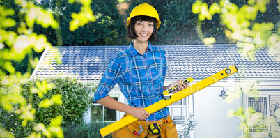 Composite image of female architect holding measuring equipment against grey background