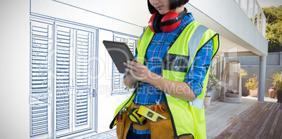 Composite image of female architect using digital tablet