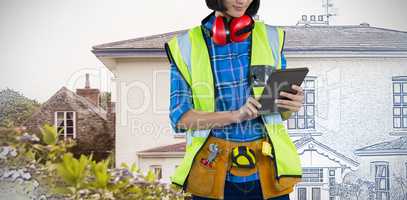 Composite image of female architect using digital tablet