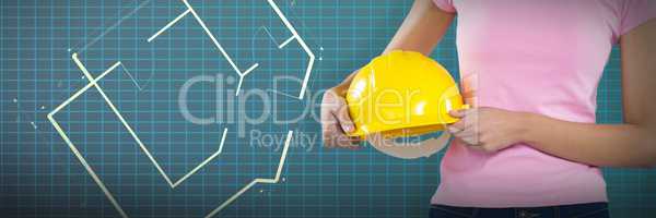 Composite image of woman holding hard hat against grey background