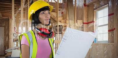 Composite image of female architect holding blueprint against white background
