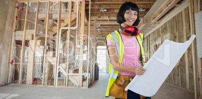 Composite image of female architect holding blueprint against white background